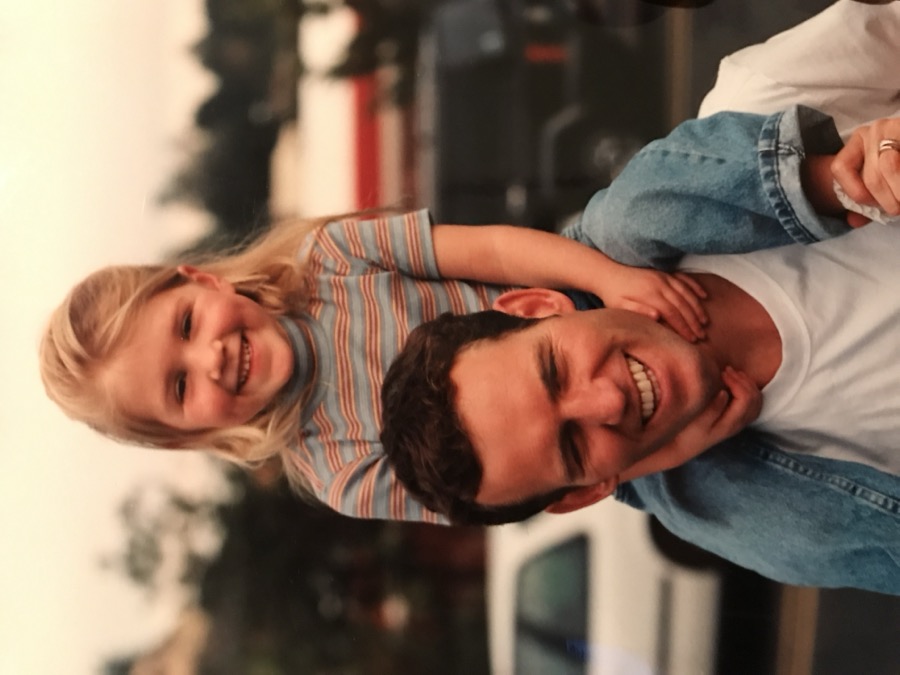 Makena as a kid, on her dad's shoulders