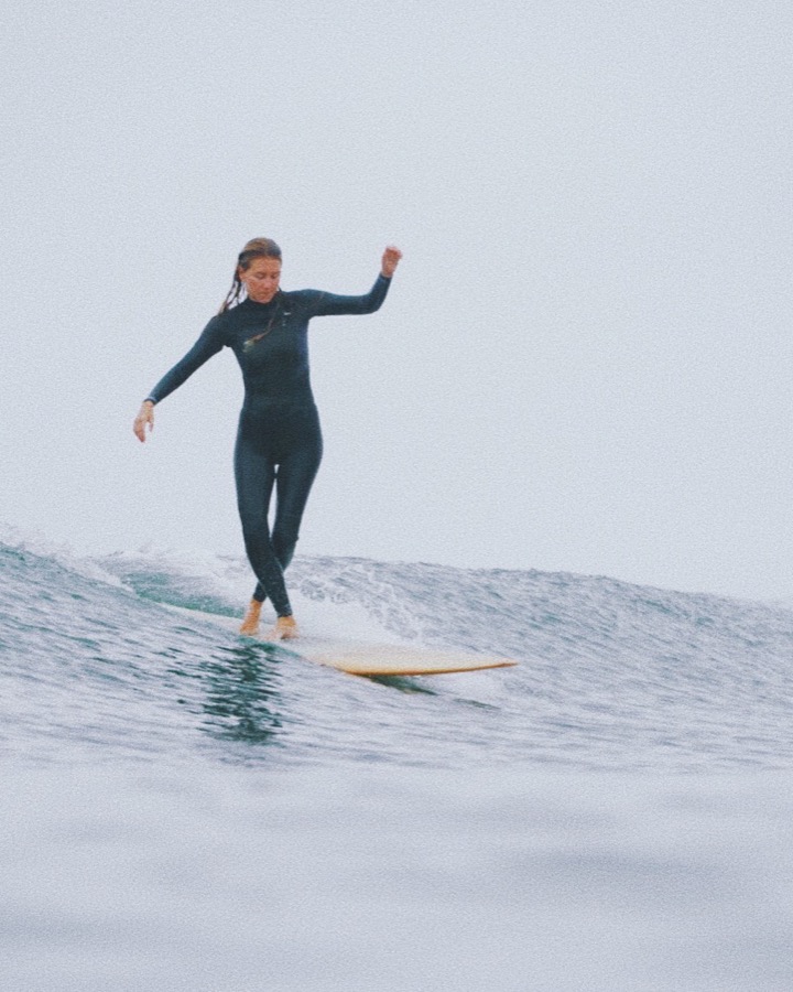 Makena walking the nose on a longboard